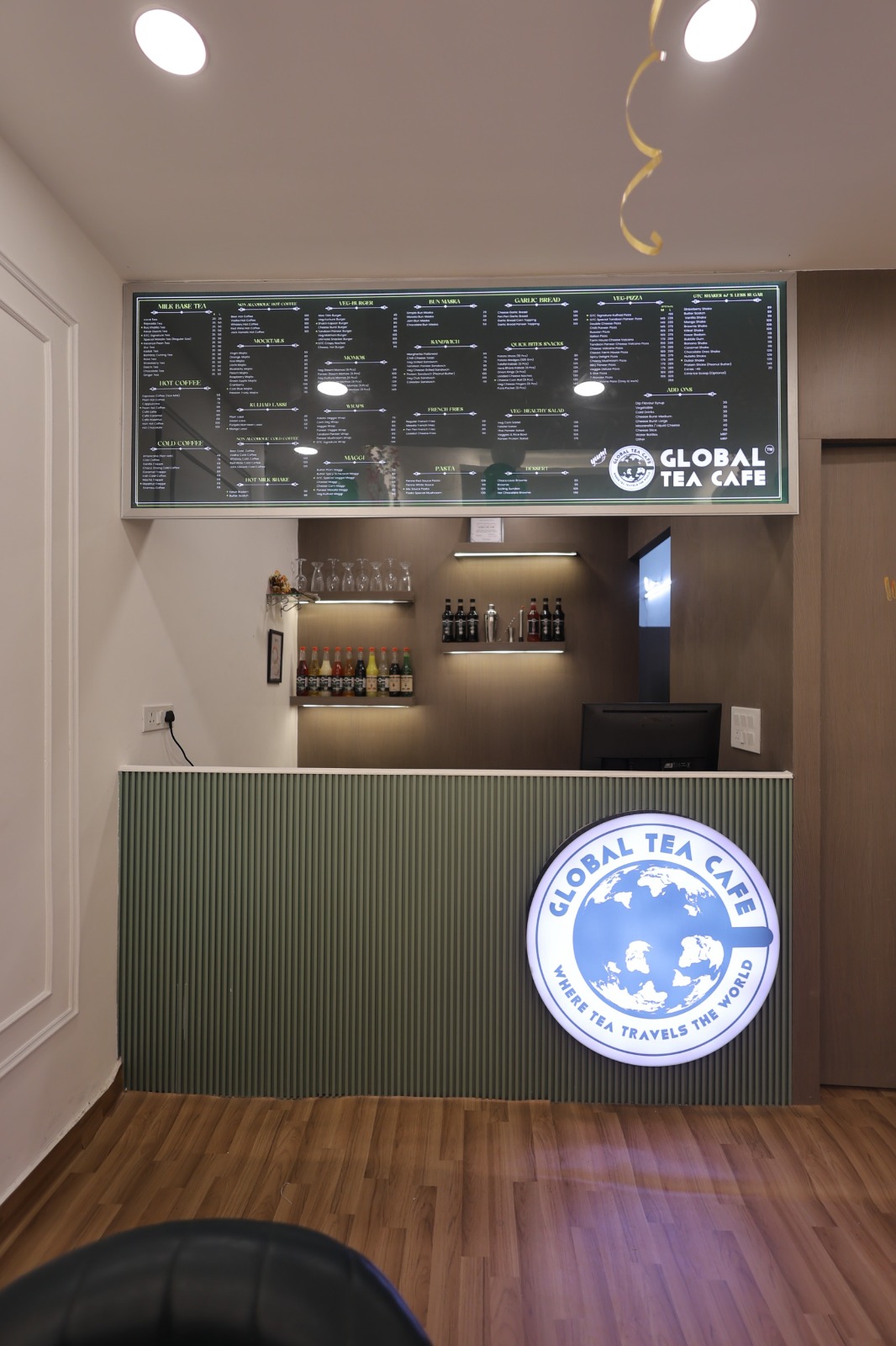 Global Tea Cafe reception counter with modern interior and welcoming design